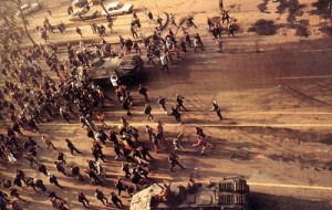 Romanian_Revolution_1989_Demonstrators image of romanian demonstrators fleeing from armed forces on the streets of bucharest in 1989