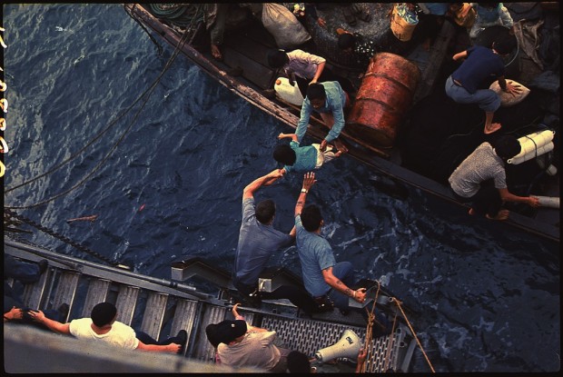 South China Sea. Crewmen of the amphibious cargo ship USS Durham (LKA-114) take Vietnamese refugees aboard a small NARA - 558518 by Unknown or not provided - U.S. National Archives and Records Administration. Licensed under Public Domain via Wikimedia Commons